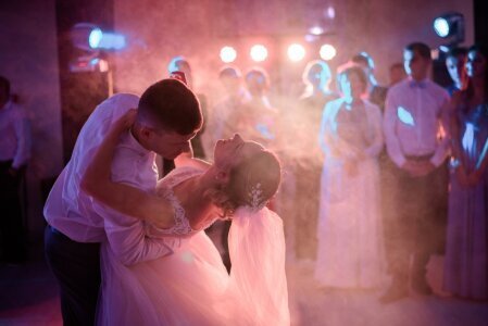 groom_bends_bride_while_they_dance_smoke_first_time